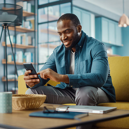 man at table on cell phone