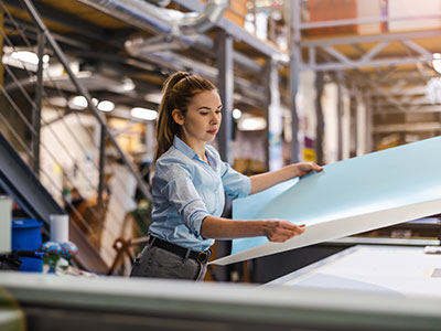 Woman preparing large sheet of paper