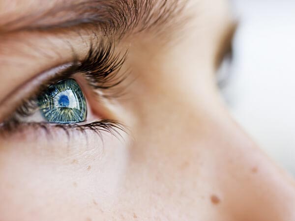 close up of woman's eye looking up
