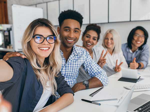 team of interns taking a photo at the work table