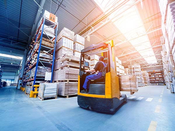 photo of a man on a forklift in a warehouse