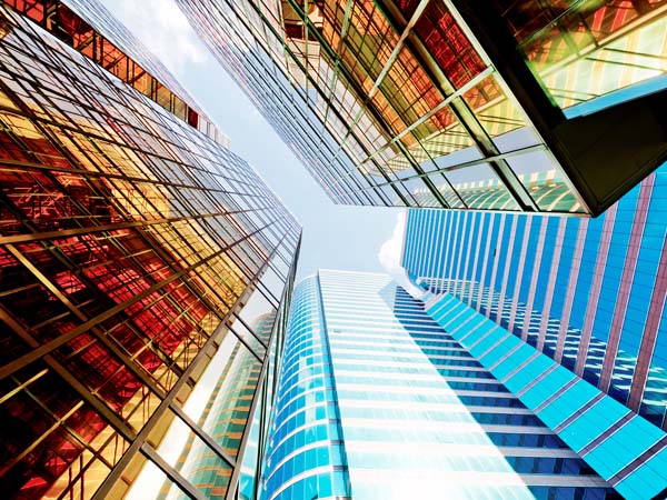 looking up at glass skyscrapers