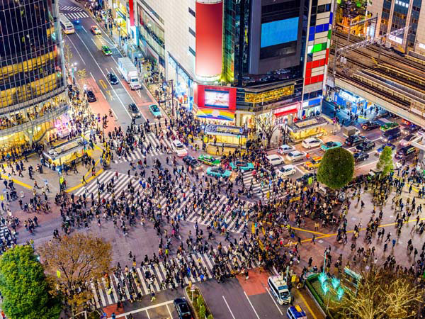 busy crowds walking through Shibuya, Tokyo, Japan