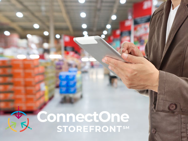 ConnectOne Storefront logo overlaying an image of a woman holding a tablet in a large warehouse setting