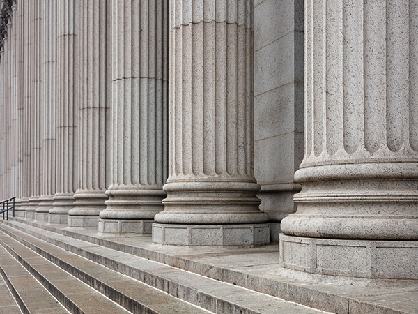 Classical building facade with stone pillars and stairs