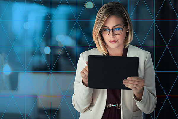 Woman holding tablet reading print impact report