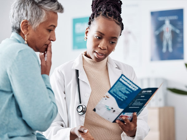 photo of a doctor reviewing a pamphlet with a patient