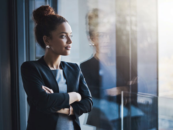 Lady with arms crossed and looking out the window