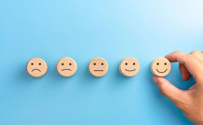 wooden circles with drawn in emotion faces