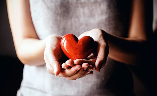 woman holding red heart