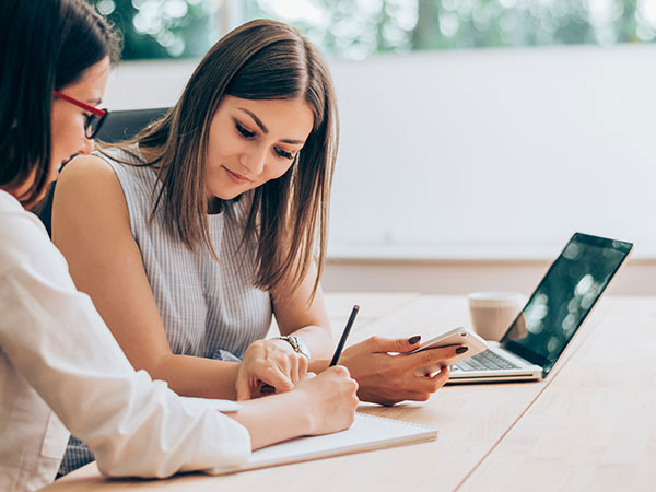 women coworkers working together at table