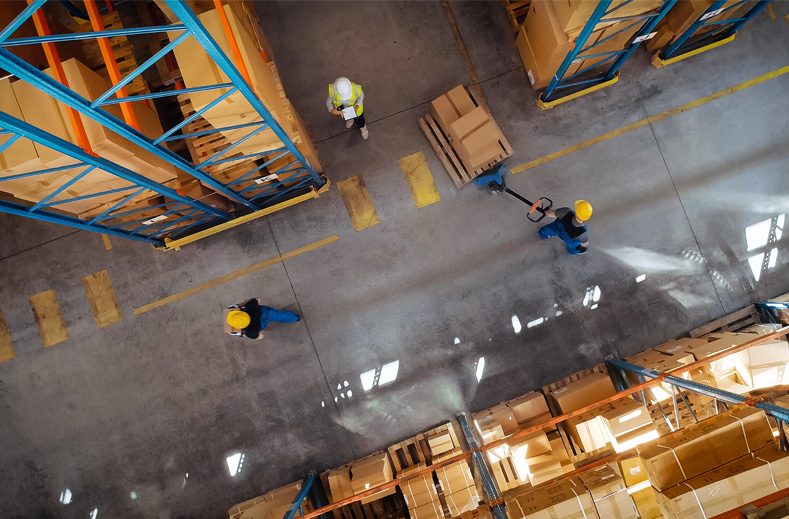 Warehouse workers moving boxes