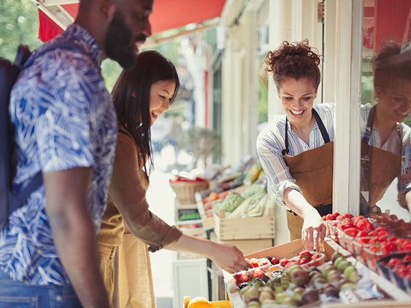 Multicultural group shopping at fresh fruit market