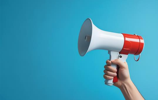 photograph of a megaphone against a blue background