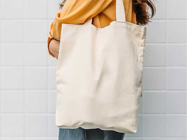 Woman holding canvas bag