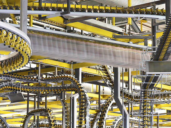 Yellow conveyer belts moving printed materials