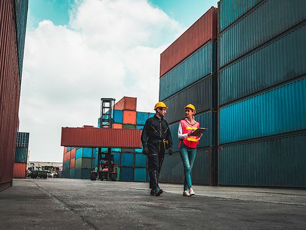 man and woman working in shipping yard