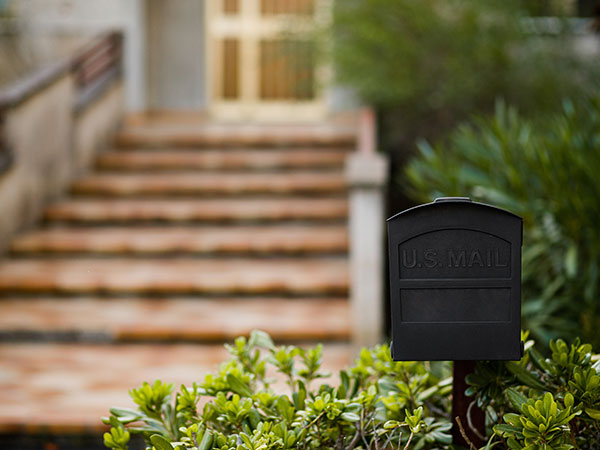 Metal mail box in front of a house