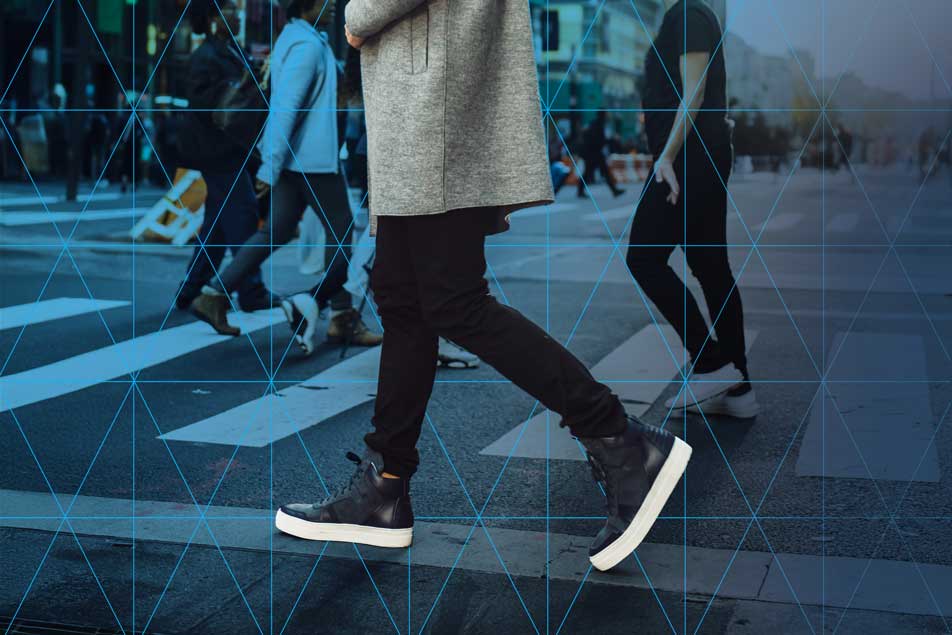 a man walking in front of a digitized background