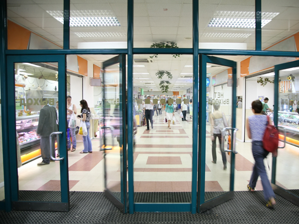 woman walking into a storefront
