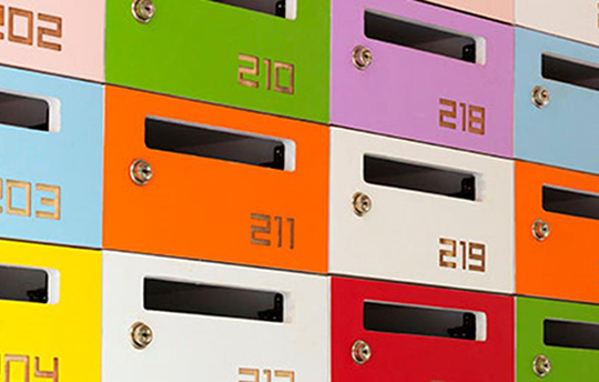 mail slots for an apartment building in a variety of colors