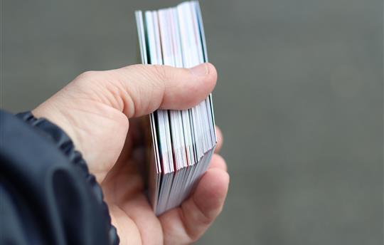 hand holding trading cards