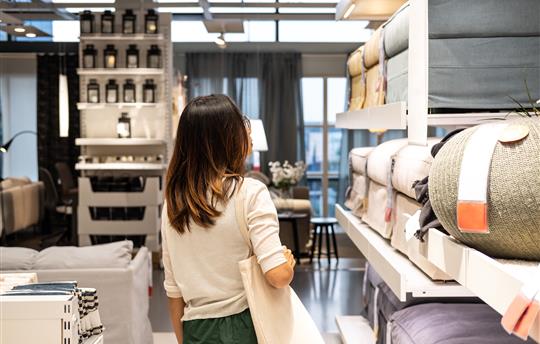 Woman choosing furniture in a modern home furnishings store