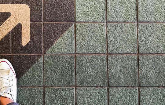 white shoes on the pavement next to an arrow