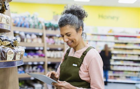 grocery clerk using a tablet