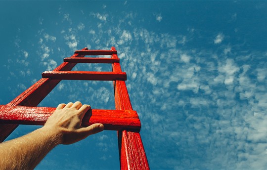 man's hand on a ladder to the sky
