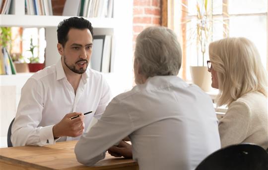 Man consulting elderly couple