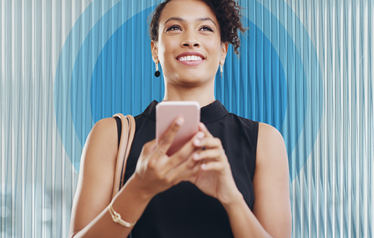 Woman holding her phone and smiling